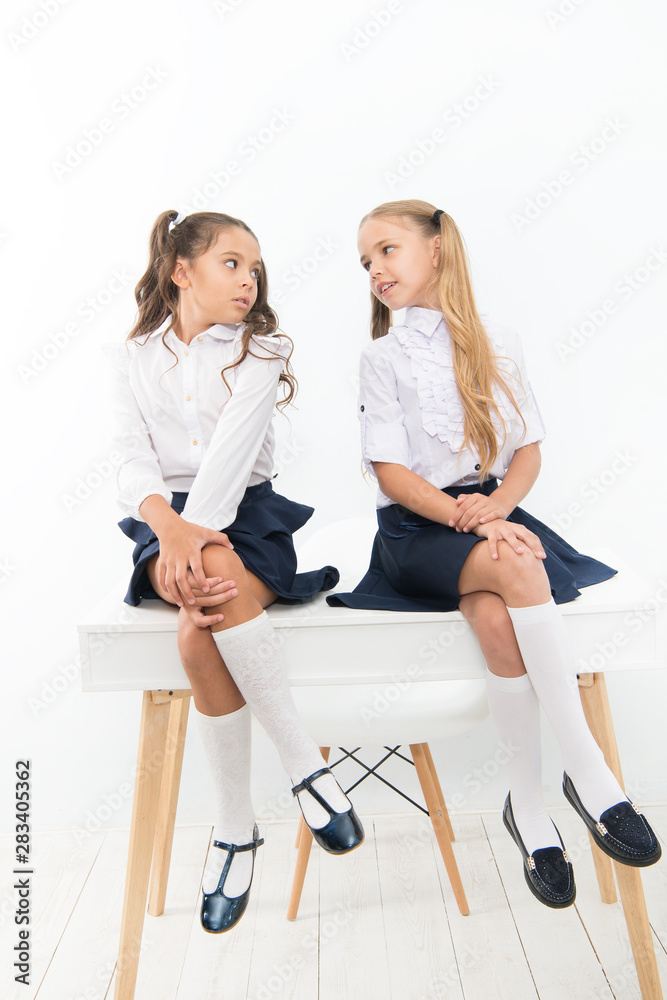 schoolgirls Competitors. Every day better. Little schoolgirls classmates friendly kids.  Schoolgirls friends sit on desk. Best friends relaxing. Schoolgirls tidy  hairstyle relaxing having rest. School uniform の Stock フォト | Adobe Stock