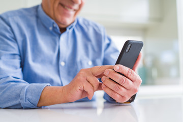 Wall Mural - close up of man hands using smartphone and smiling confident