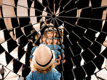 Girl's Reflection In Many Mirrors Arranged In A Parabolic Shape. Multiple Points Of View, Multiple Angles. Fragmented Multi-faceted Portrait. Mirror Array.