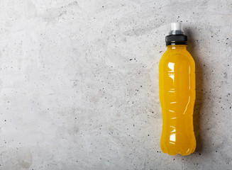 Isotonic energy drink. Bottles with blue transparent liquid, sport beverage on a gray concrete background