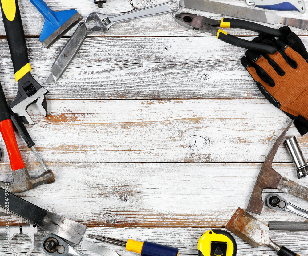 Labor Day concept with circle border of industrial worker tools over  distressed white wooden background Stock Photo | Adobe Stock, image size:1000x831