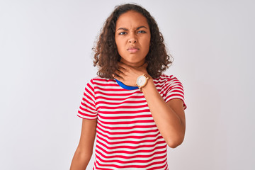 Young brazilian woman wearing red striped t-shirt standing over isolated white background cutting throat with hand as knife, threaten aggression with furious violence