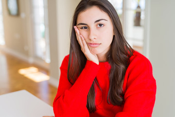 Canvas Print - Beautiful young woman wearing casual red sweater thinking looking tired and bored with depression problems with crossed arms.