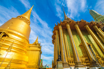 Emerald buddha temple golden pagoda blue sky with cloud sightseeing in Bangkok