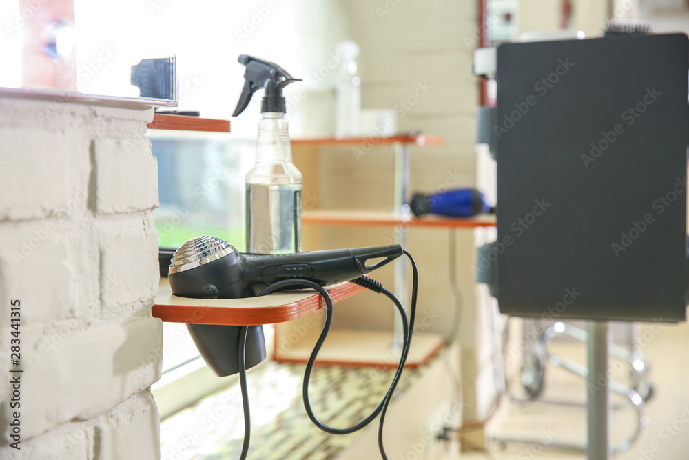 Professional blow drier in hairdressing salon