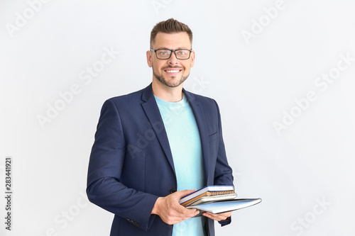 Cuadros en Lienzo Handsome male teacher on light background