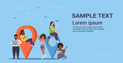 Poster - people using colorful geo tags pointers mix race men women holding digital gadgets near location markers gps navigation concept flat full length horizontal copy space
