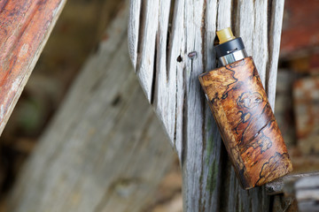 high end natural stabilized wood box mods with rebuildable dripping atomizer, vaping device, selective focus