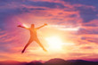 © tonktiti - Happy man jumping at top of mountain with sunset sky abstract background.
