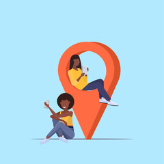 Poster - girls couple using geo tag pointer african american women holding digital gadgets near location marker gps navigation concept flat full length