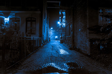 dark and scary vintage cobblestone brick city alley at night in chicago