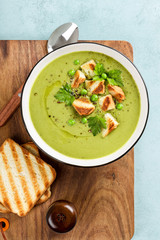 Sticker - Pea soup. Green pea puree soup in a bowl served with grilled toasts, top view