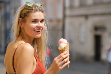Wall Mural - cheerful girl eating ice cream cone