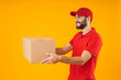 © Drobot Dean - Image of pleased delivery man in red uniform smiling and holding packaging box