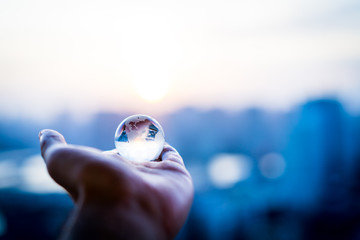 Crystal globe against the sunset sunlight from the skyscraper