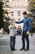 © Aleksandr - Younger brother give five to older brothe in the city