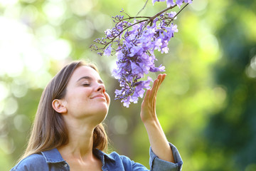 Candid woman smelling flowers in a park