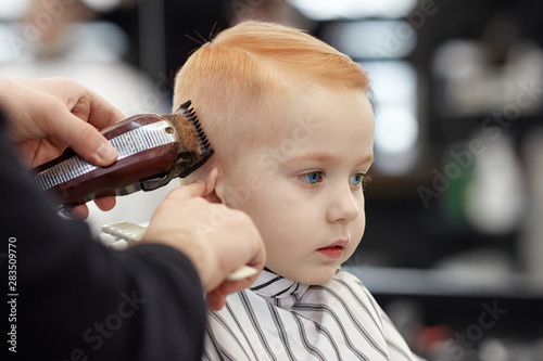 Cute Ginger Baby Boy With Blue Eyes In A Barber Shop Having