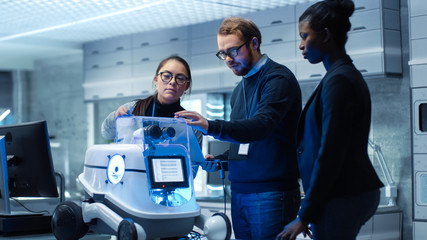Wall Mural - multi ethnic team of male and female leading scientists work on innovative robotics technology. they