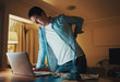 © StratfordProductions - Man working late at night suffering from back pain