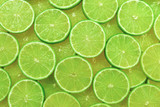 Fototapeta Panele - Fresh lime slices as a background.