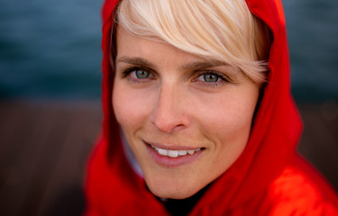 Close-up portrait of young woman standing outdoors on beach.