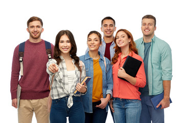 Wall Mural - education, high school and people concept - group of smiling students with books and bags pointing at you over white background