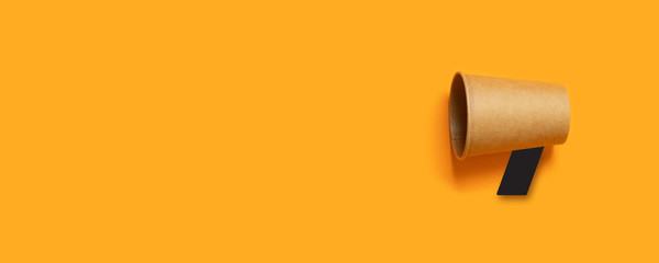 Wall Mural - attention concept announcement. business concept image with paper cup megaphone on panoramic orange 