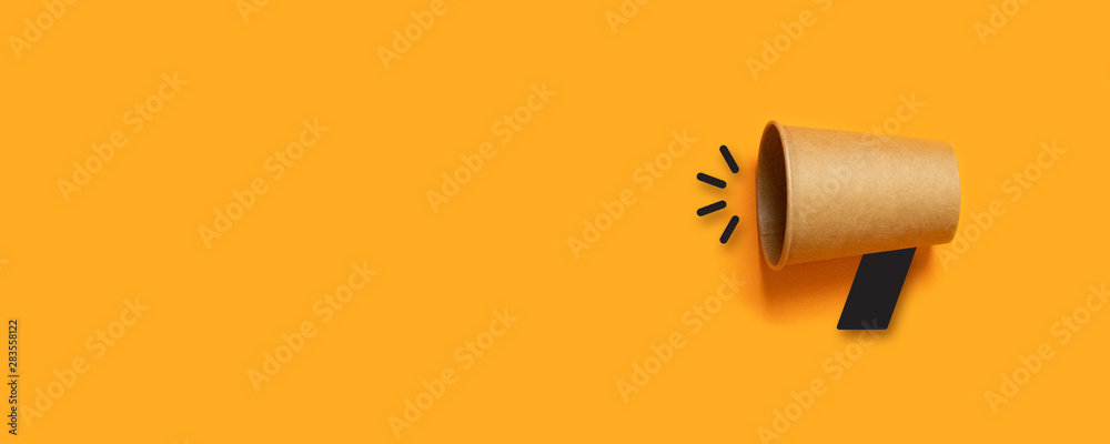 Refer a Friend. Business concept image with paper cup megaphone on orange background with copy space. Attention concept announcement. Minimal flat lay - obrazy, fototapety, plakaty 