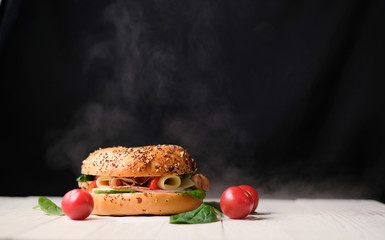 Delicious classic blt sandwiches with ham, cheese, bacon, tomatoes. Breakfast and fast food meal. on isolated black background wooden and text copy space.