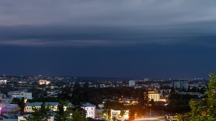 Wall Mural - timelapse with Panoramic summer view of the city of Kutaisi, Georgia. River Rioni and old houses with Red roofs. night thunderstorm over Kutaisi and Mountains in the distance.