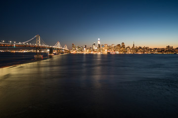 Wall Mural - Panoramic beautiful scenic view of the Oakland Bay Bridge and the San Francisco city in the evening, California, USA