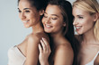 © LIGHTFIELD STUDIOS - three multiethnic smiling girls in underwear embracing isolated on grey