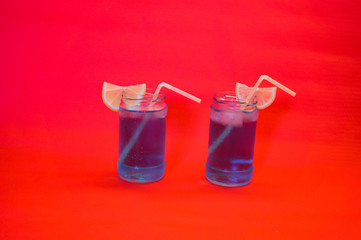 Two refreshing cocktails with lemon and straw