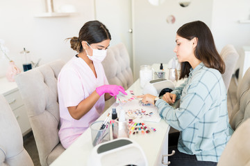 Employee Taking Care Of Customer's Choice In Salon