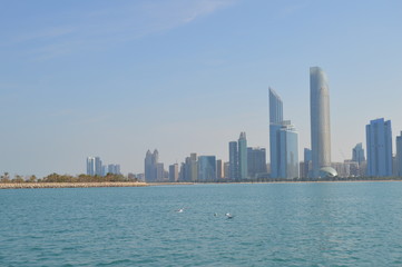 Wall Mural - Abu Dhabi city skyline along Corniche beach taken from a boat