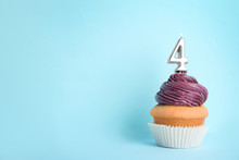Birthday Cupcake With Number Four Candle On Blue Background, Space For Text