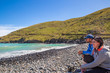 © Sheryl - A couple enjoy the peacefulness of the scenic view at one of the bays on Banks Peninsula while out on a day trip