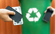 © phoenix021 - E waste , recycle concept , disassembled smartphone and recycle bin in background