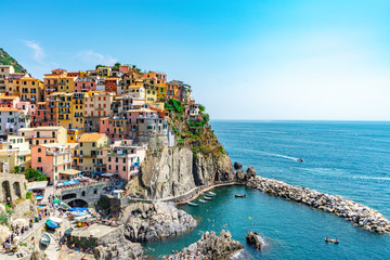 Amazing view of Manarola village in Cinque Terre, Italy. Sunny day and blue sky of an afternoon in the European summer. Unesco World Heritage Site