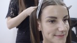 Fototapeta Zwierzęta - Cute girl with long brunette hair hairdresser doing hair lamination in a beauty salon. concept of hair care treatment 