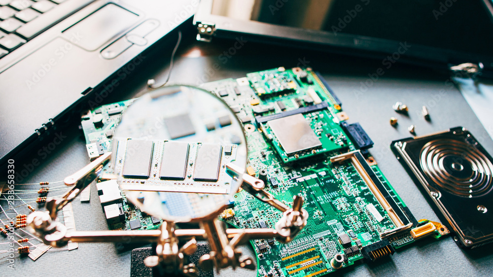 Computer analysis. Closeup of disassembled laptop parts through ...
