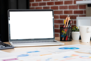 Aufkleber - mockup laptop computer screen with business chart market,caculator,coffee cup,pencil box on desk at brick wall at modern office meeting room.device template for display of design.clipping path screen.