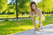© fotofabrika - Sporty woman in running start pose in the city park