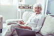 © zinkevych - Stylish elegant elderly lady feeling relaxed having rest in living room