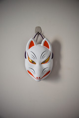 japanese mask of fox on white wall