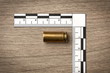 Crime Scene Investigation - bullet casing as a piece of evidence placed with forensic ruler for documentation