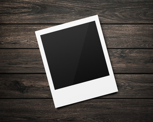 Poster - Empty polaroid photo frames mockups template on a wooden table background for putting your pictures. Paper sheet for printing images or recording picture of film cameras.