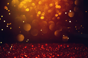 Golden abstract bokeh on black background.