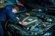 © Maxim - Mechanic working in car motor. Auto repair, Service center. Mechanic with wrench working and repair car engine in car service centre.